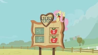 Fluttershy with a flower in her mouth.