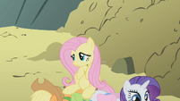 Fluttershy sitting on Applejack and Rarity S1E07