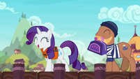 Rarity approaches the ship with a porter pony S6E22