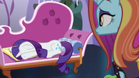 Rarity crying with her face in the photo album S7E6