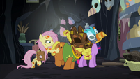 Fluttershy shoves Twilight and Cattail toward the door S7E20