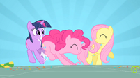 Pinkie knocks over Twilight in her enthusiasm.