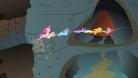 Pinkie Pie riding Fluttershy as they are being dragged down into the caves system S1E19