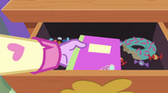 Twilight puts Fluttershy's notebook in the drawer EG2