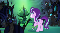 Thorax looks at Queen Chrysalis in her throne S6E26
