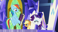 Rainbow Dash shows Rarity's page to her S7E14
