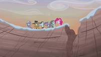 Pie family looking over the cliff S5E20