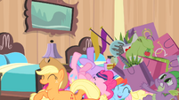 Rarity's friends laughing while Spike carries Rarity's bags S4E08