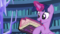 Twilight Sparkle flips through the journal's pages S7E14