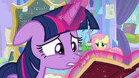 Twilight desperately looks through a book S9E25