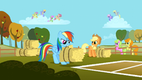 Rainbow Dash tossing a bale of hay S1E13