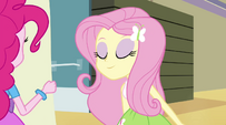 Fluttershy sniffing the poster EG2