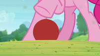 Pinkie Pie standing over a buckball S9E15