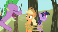 From the look on Applejack's face, Spike doesn't have bad breath.