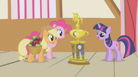 Applejack and Pinkie gazing at the trophy S1E04