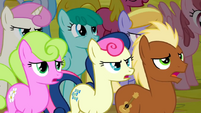The pony with the pink mane in the back has the same expression as Sweetie Drops.
