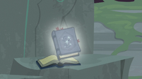 Image of Star Swirl's journal falls to rock pedestal S7E25