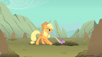 Applejack tries to pull Spike out of a hole S1E19