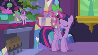 Twilight levitates present into Spike's hands S5E20