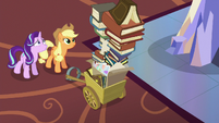 Starlight looks up at Applejack's photo albums S6E21