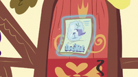 Contest flyer being hung on Ponyville house door S7E9