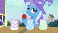 Trixie with red ball and three paper cups S7E24