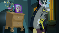 Discord looking at picture of himself and Fluttershy S4E25