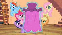 Applejack admires the cape Rarity made.