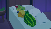 Pillows and fruit bunched up on hotel bed S8E5