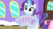Rarity showing the tickets S4E08