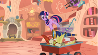 Twilight looking at items on the wagon S1E24