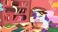 Rarity covering her head with a book S1E8