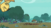 Roc picks up clumps of dirt with its claws S8E11