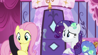 Fluttershy slings the black dress across her back S5E21