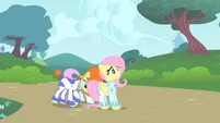 Pushing Fluttershy away.