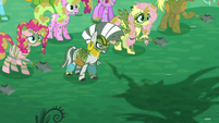 Zecora and ponies look at Chrysalis while her shadow appears S5E26