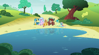 Friendship students sitting by the lake S8E1