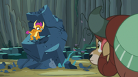 Smolder clawing at the giant rock S9E3