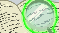 Magnifying glass peering over book text S8E16