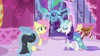Rarity levitates masquerade dress in front of Fluttershy S5E21