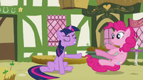 Twilight pushing Pinkie away.