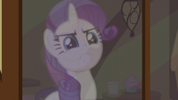 A reflection of Rarity looking serious S5E19