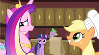 Applejack looks pleased, but Cadance looks disturbed.