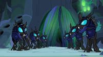 Changeling guards watch the chamber doors close S6E26