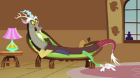 Discord lounges on Fluttershy's couch.