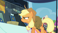 Applejack looking closely at brooch S4E22