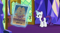 Rarity levitating a Daring Do poster S5E3