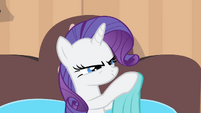 Rarity rubs on a blanket.