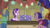 Starlight sitting next to Trixie's stage trunk S8E19