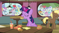 Twilight eating while foals behind windows look at her S4E15